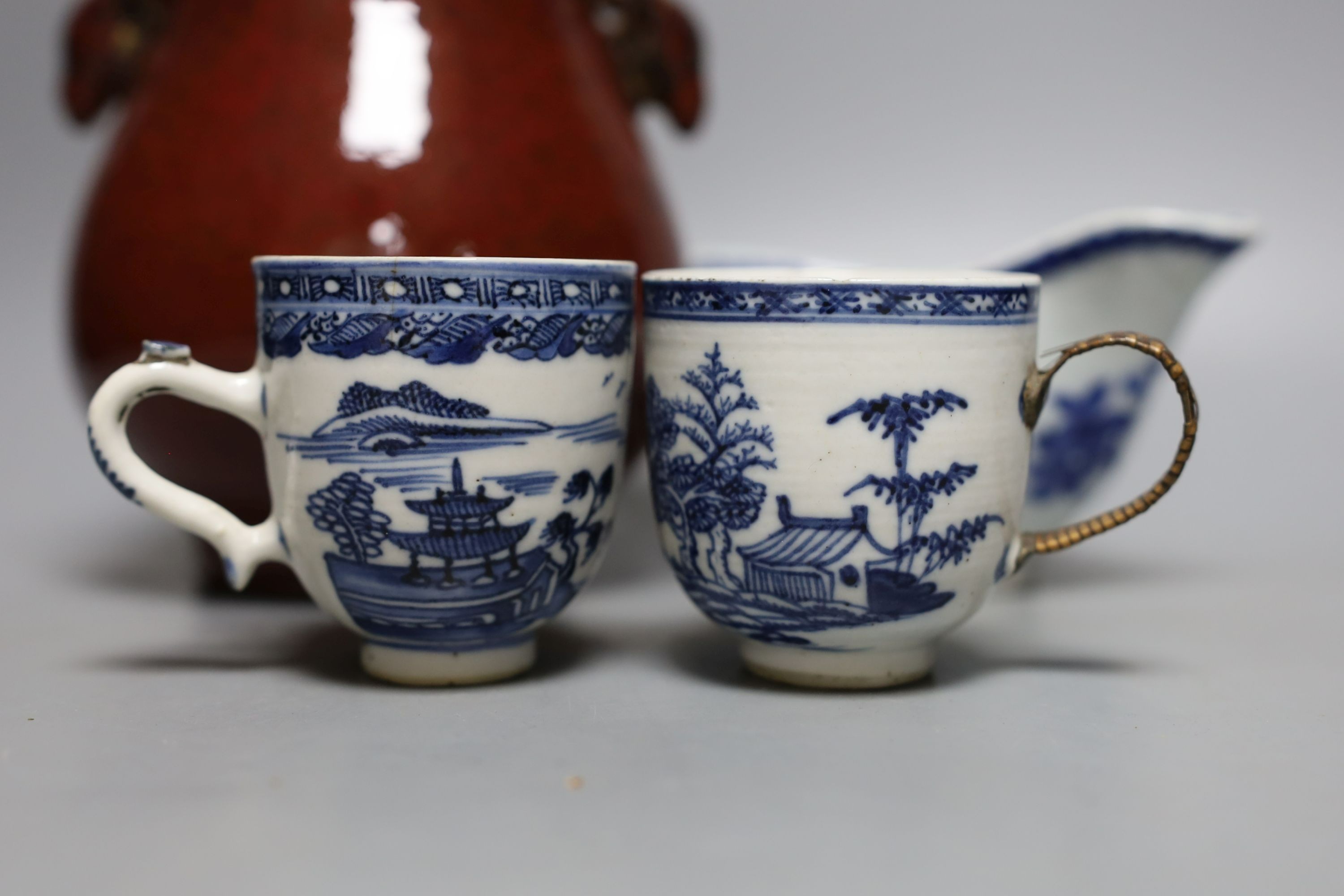 An 18th century Chinese export tea cup, 3 pieces of export blue and white and a sang de boeuf vase. Tallest 16cm